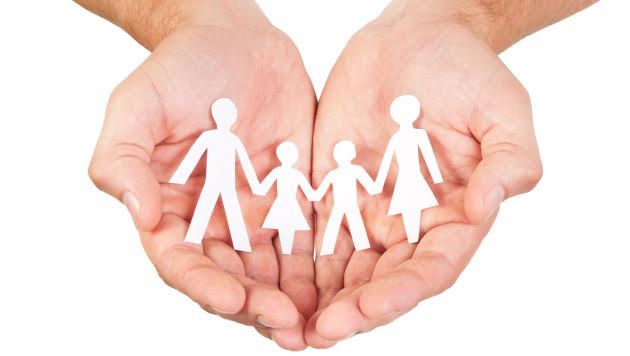 Paper family in hands isolated on white background